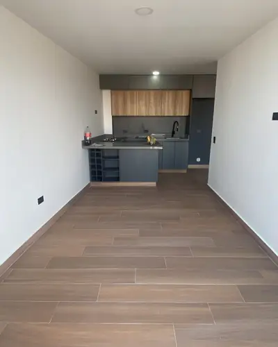 Apartamento terminado con piso tipo madera y cocina integral al fondo